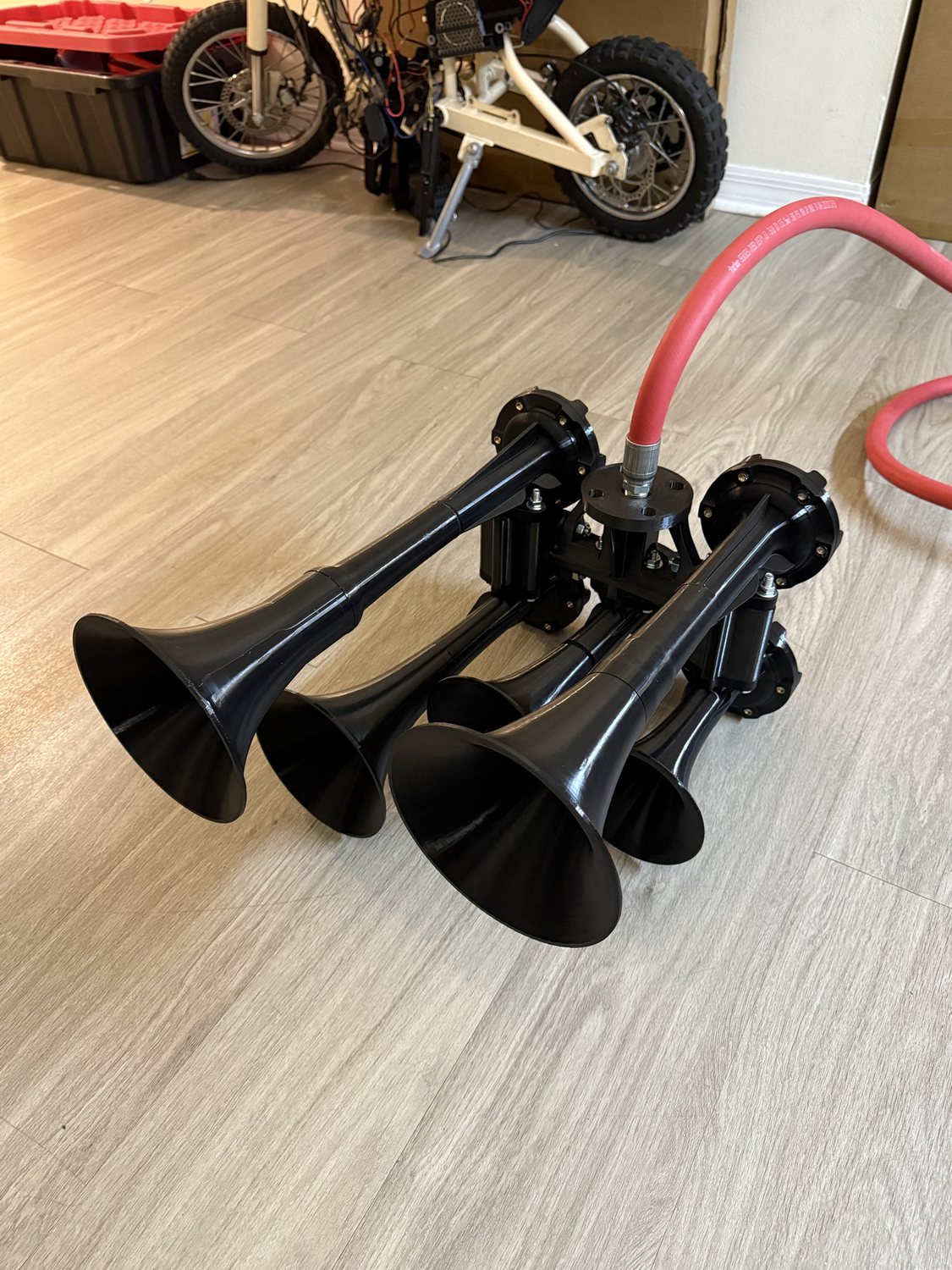 A built T5 on the floor with a red air line connected to its foot